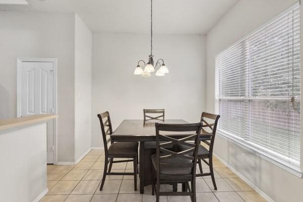 4526 Cannongate Dr, Spring Branch, TX 77373 - dining room with light tile patterned flooring and a chandelier