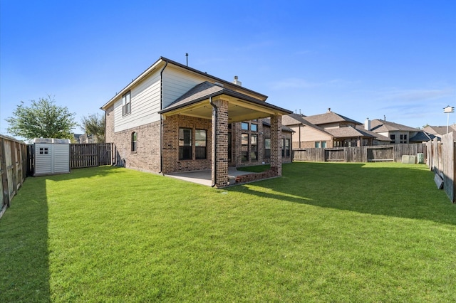 31183 Pecan Creek Dr, Brookshire, TX 77423 - rear view of house with a patio, a fenced backyard, a shed, brick siding, and an outbuilding