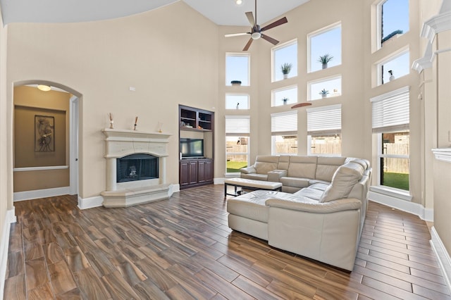 31183 Pecan Creek Dr, Brookshire, TX 77423 - living area with ceiling fan, dark wood finished floors, baseboards, a healthy amount of sunlight, and a towering ceiling