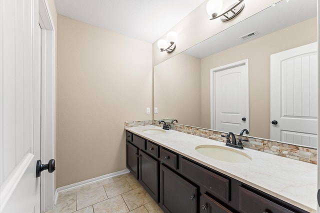 31183 Pecan Creek Dr, Brookshire, TX 77423 - bathroom featuring double vanity, baseboards, visible vents, and a sink