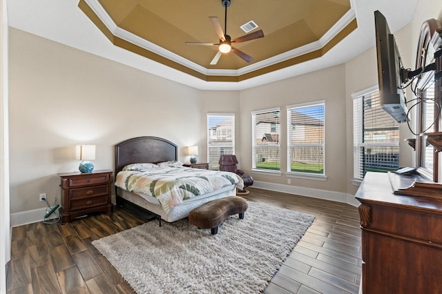 31183 Pecan Creek Dr, Brookshire, TX 77423 - bedroom featuring crown molding, dark wood-style flooring, a raised ceiling, baseboards, and visible vents