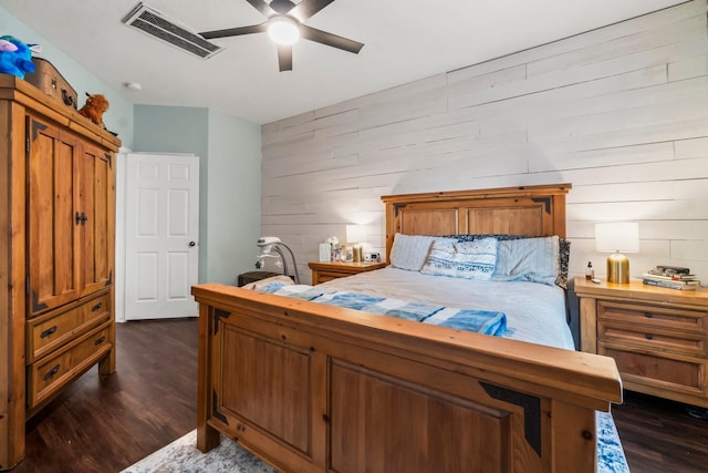 14854 Altair Ct, Willis, TX 77318 - bedroom with visible vents, dark wood finished floors, ceiling fan, and wooden walls