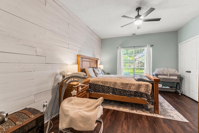 14854 Altair Ct, Willis, TX 77318 - bedroom featuring ceiling fan, visible vents, wood finished floors, wooden walls, and an accent wall