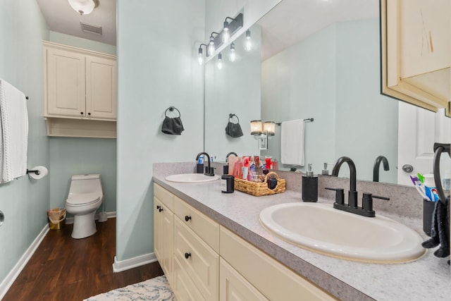14854 Altair Ct, Willis, TX 77318 - full bath with visible vents, a sink, baseboards, and wood finished floors