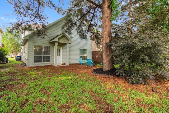 14854 Altair Ct, Willis, TX 77318 - rear view of property with central air condition unit