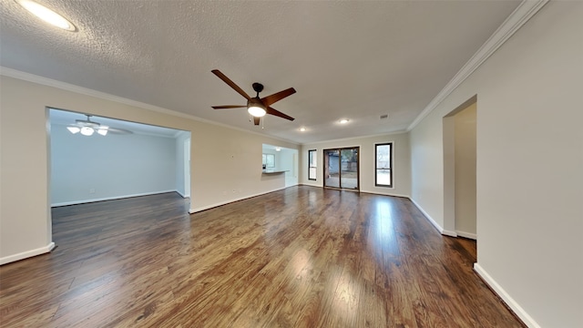 unfurnished room featuring crown molding, baseboards, ceiling fan, and dark wood finished floors