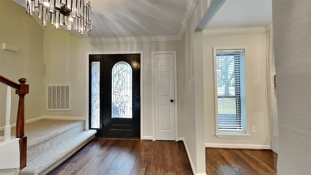 entrance foyer featuring visible vents, ornamental molding, stairs, and a wealth of natural light