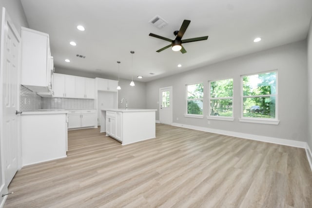 unfurnished living room with visible vents, baseboards, ceiling fan, recessed lighting, and light wood-style flooring