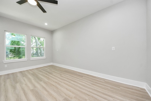 empty room featuring baseboards, recessed lighting, light wood-style flooring, and ceiling fan