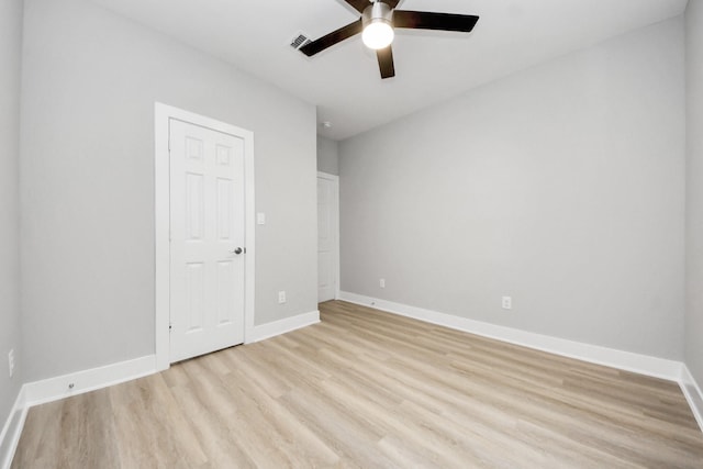 unfurnished bedroom featuring a ceiling fan, baseboards, visible vents, and light wood-style flooring