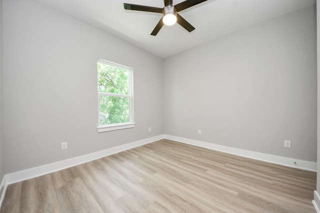 unfurnished room featuring a ceiling fan, baseboards, and light wood-style flooring
