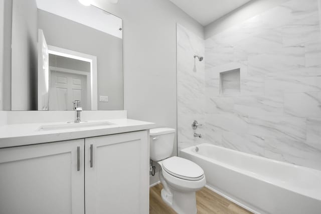 full bath featuring vanity, toilet, wood finished floors, and shower / bathing tub combination