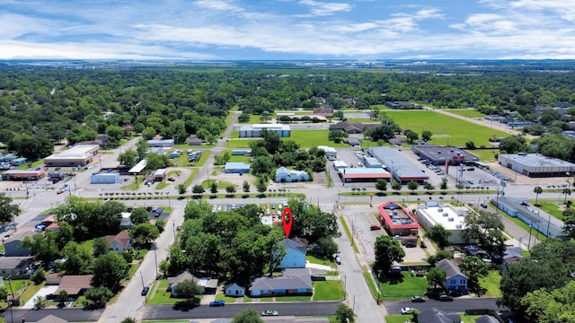 birds eye view of property with a view of trees