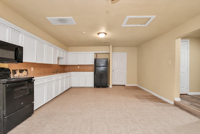 kitchen featuring light tile patterned flooring, white cabinetry, black appliances, and tasteful backsplash