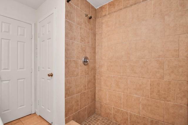 full bath with tile patterned floors and a tile shower
