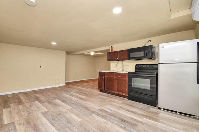 kitchen featuring light wood-type flooring, recessed lighting, black appliances, and light countertops