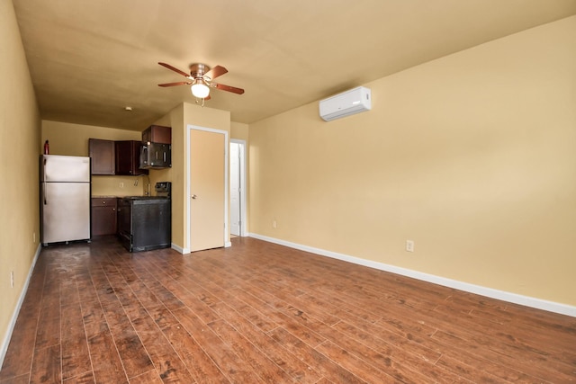 unfurnished living room with baseboards, ceiling fan, a wall unit AC, and dark wood-style flooring