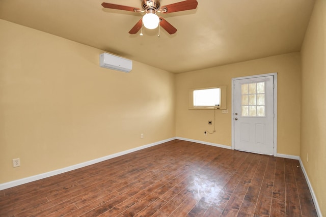 unfurnished room with baseboards, a wall mounted AC, dark wood-style floors, and ceiling fan