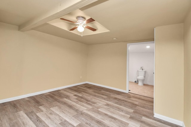 empty room featuring light wood-type flooring, baseboards, and ceiling fan