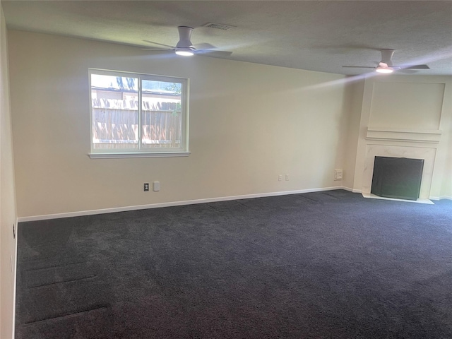 20018 Big Timber Dr, Humble, TX 77346 - unfurnished living room with ceiling fan, dark colored carpet, a fireplace with flush hearth, and baseboards