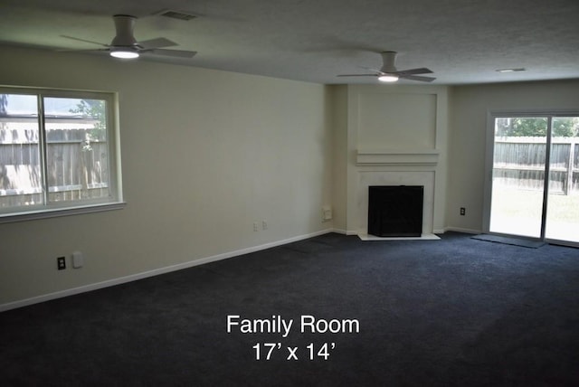 20018 Big Timber Dr, Humble, TX 77346 - unfurnished living room featuring ceiling fan, dark carpet, a fireplace, and baseboards