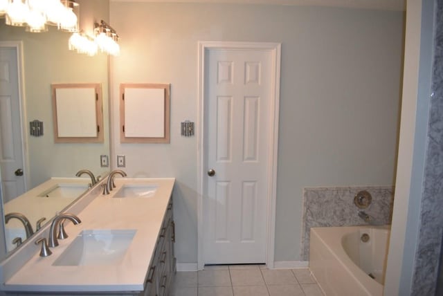 20018 Big Timber Dr, Humble, TX 77346 - bathroom with tile patterned floors, a garden tub, double vanity, a chandelier, and baseboards