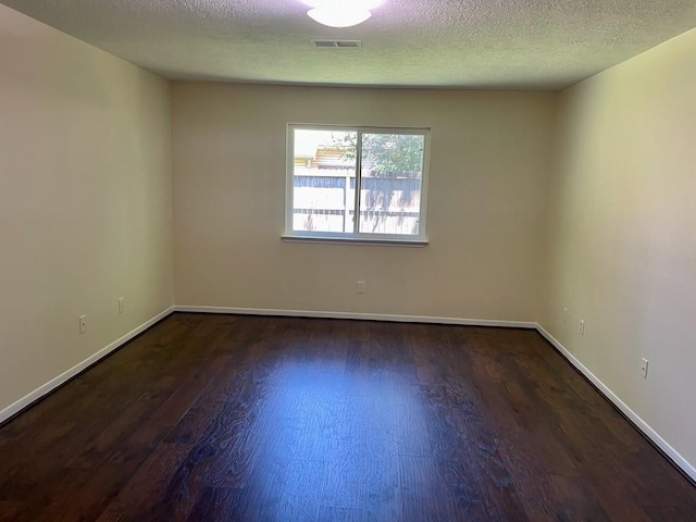 20018 Big Timber Dr, Humble, TX 77346 - unfurnished room with wood finished floors, a textured ceiling, and baseboards