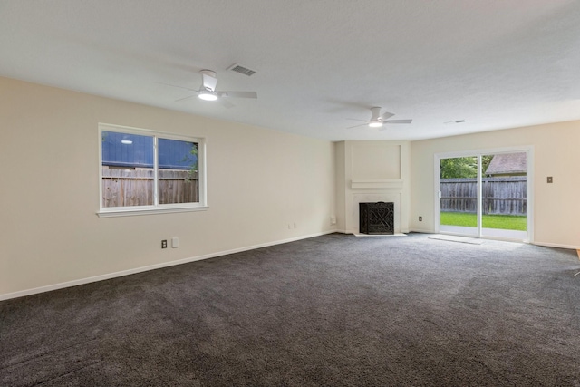 20018 Big Timber Dr, Humble, TX 77346 - unfurnished living room with ceiling fan, a fireplace with flush hearth, dark colored carpet, and baseboards