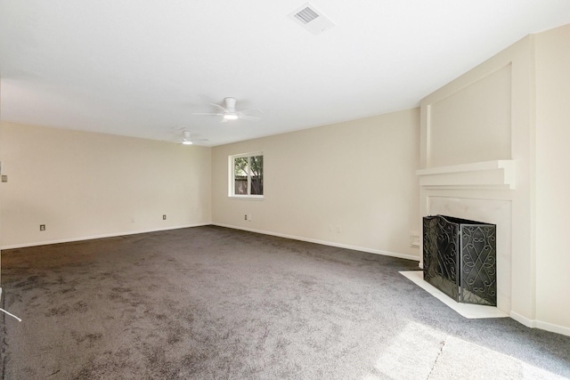 20018 Big Timber Dr, Humble, TX 77346 - unfurnished living room featuring carpet flooring, a ceiling fan, a fireplace with flush hearth, and baseboards