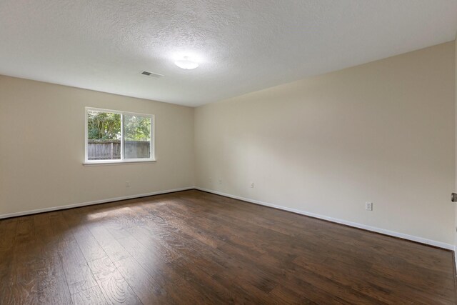 20018 Big Timber Dr, Humble, TX 77346 - spare room with dark wood finished floors, baseboards, and a textured ceiling