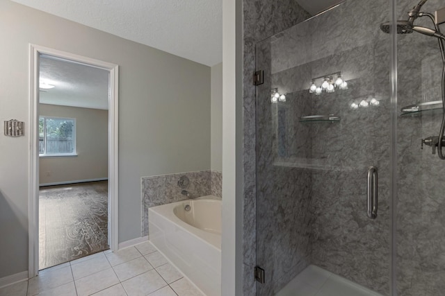 20018 Big Timber Dr, Humble, TX 77346 - bathroom with a bath, tile patterned floors, a shower stall, baseboards, and a textured ceiling