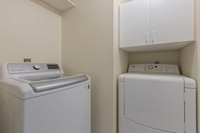 20018 Big Timber Dr, Humble, TX 77346 - washroom featuring washing machine and clothes dryer and cabinet space