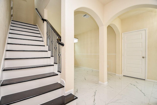 6326 Prince Place Dr, Rosenberg, TX 77471 - stairway with marble tiled floors, baseboards, and arched walkways