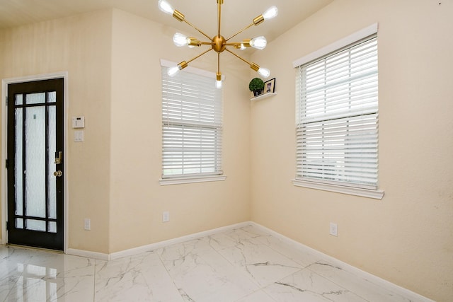 6326 Prince Place Dr, Rosenberg, TX 77471 - unfurnished dining area with a chandelier, marble look tile flooring, baseboards, and healthy amount of natural light