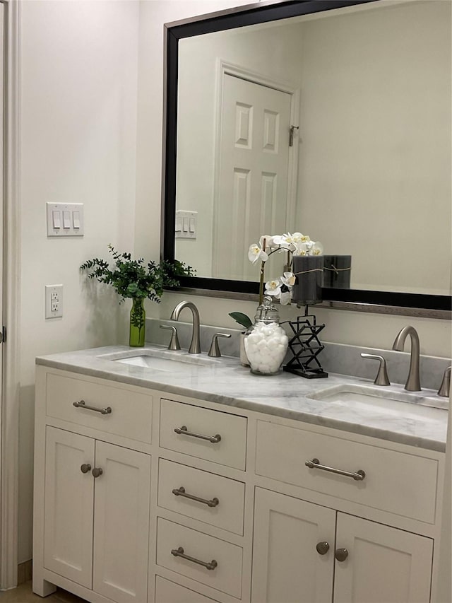 bathroom featuring a sink and double vanity