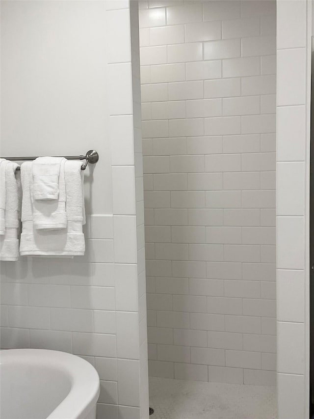 bathroom with a freestanding bath and a tile shower