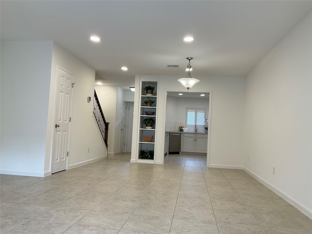 unfurnished room with recessed lighting, stairs, baseboards, and visible vents