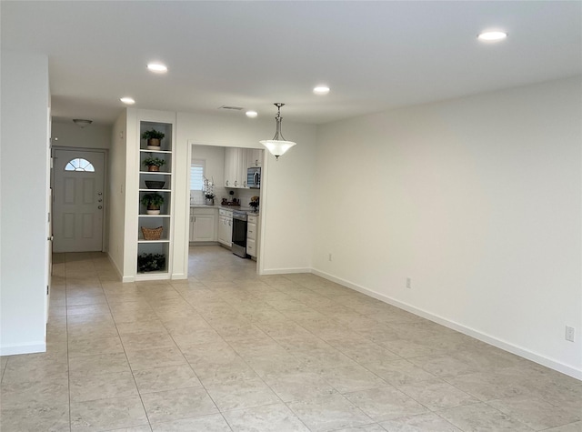 unfurnished living room featuring recessed lighting, baseboards, light tile patterned floors, and visible vents