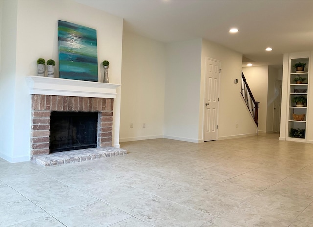 unfurnished living room with tile patterned flooring, a brick fireplace, stairs, recessed lighting, and baseboards