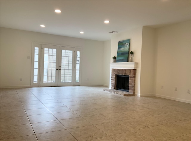 unfurnished living room featuring visible vents, recessed lighting, light tile patterned floors, and french doors