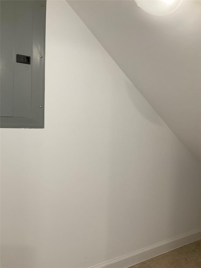 room details featuring baseboards and electric panel