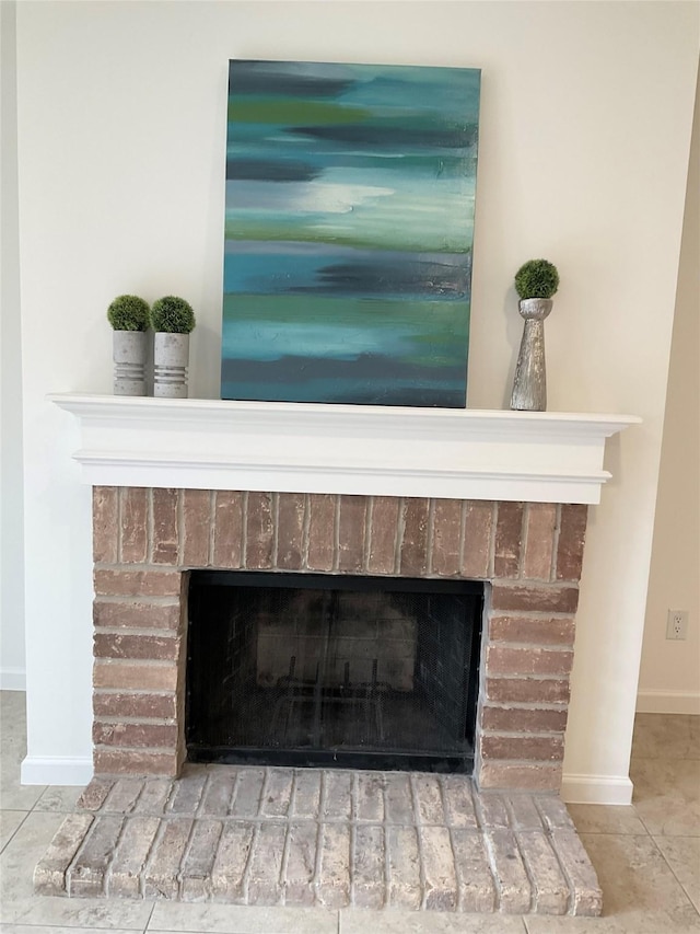 room details featuring baseboards and a fireplace