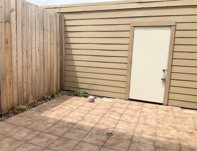view of outbuilding featuring fence