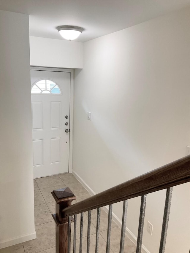 entryway featuring light tile patterned flooring and baseboards