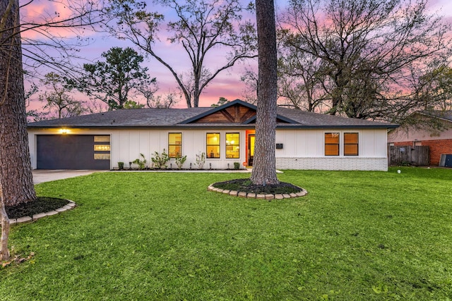 view of front facade featuring concrete driveway, board and batten siding, an attached garage, and a front yard