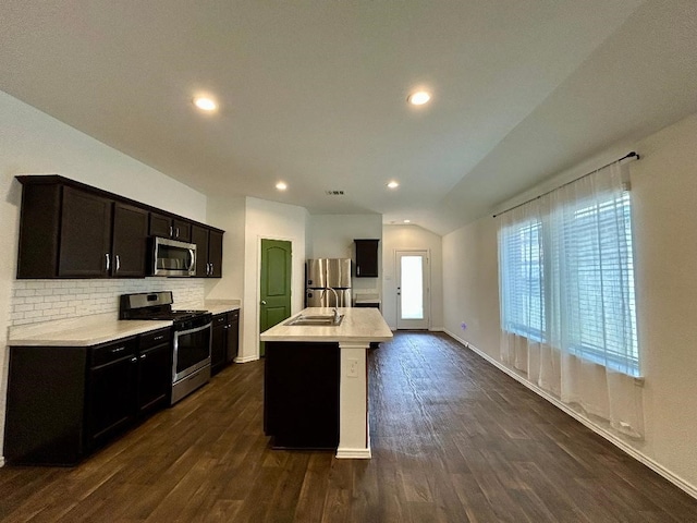 14670 Canyon Pines Ln, New Caney, TX 77357 - kitchen featuring stainless steel appliances, light countertops, dark wood-type flooring, decorative backsplash, and a sink