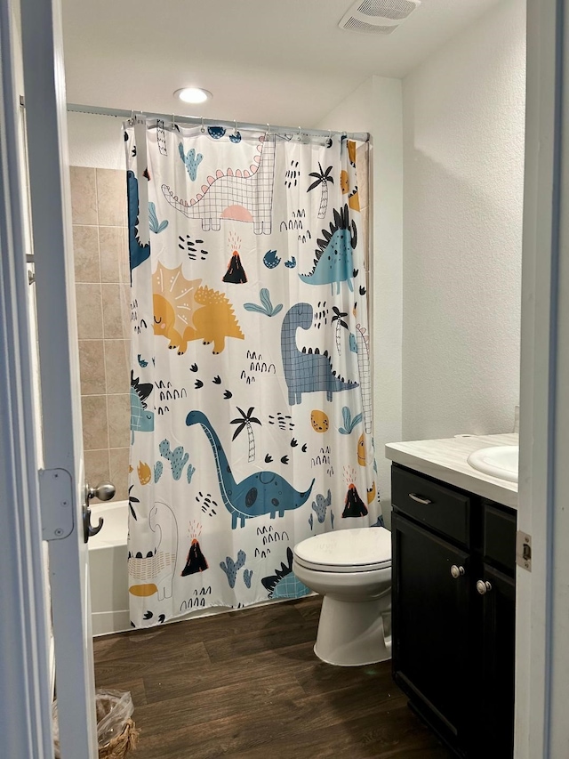 14670 Canyon Pines Ln, New Caney, TX 77357 - bathroom featuring vanity, toilet, shower / bath combination with curtain, and wood finished floors