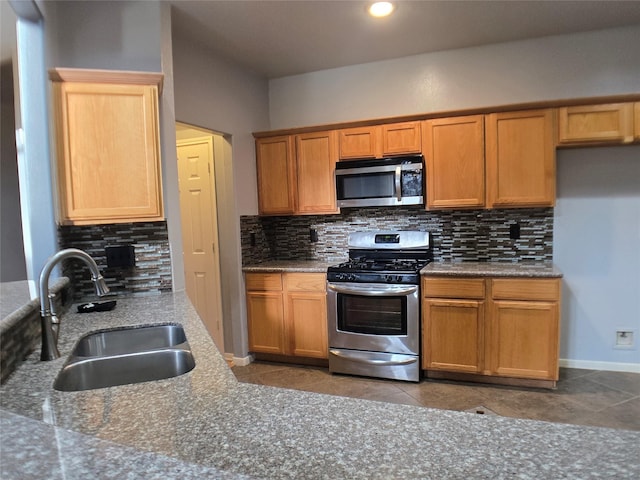 3905 Austin Lake Ct, Pearland, TX 77581 - kitchen featuring backsplash, stainless steel appliances, tile patterned floors, and a sink