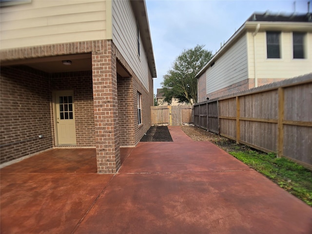 3905 Austin Lake Ct, Pearland, TX 77581 - view of home's exterior featuring a fenced backyard, a patio, and brick siding