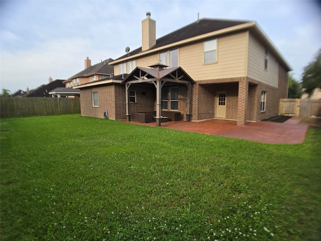 3905 Austin Lake Ct, Pearland, TX 77581 - back of property with a chimney, a lawn, a patio area, brick siding, and a fenced backyard